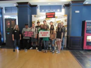 Group of participants with signs all around