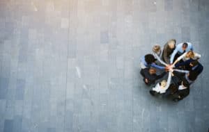 People in a group with hands in middle